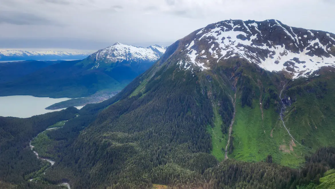 Aerial view from a TEMSCO helicopter over Juneau showing Mendenhall Lake and surrounding mountains