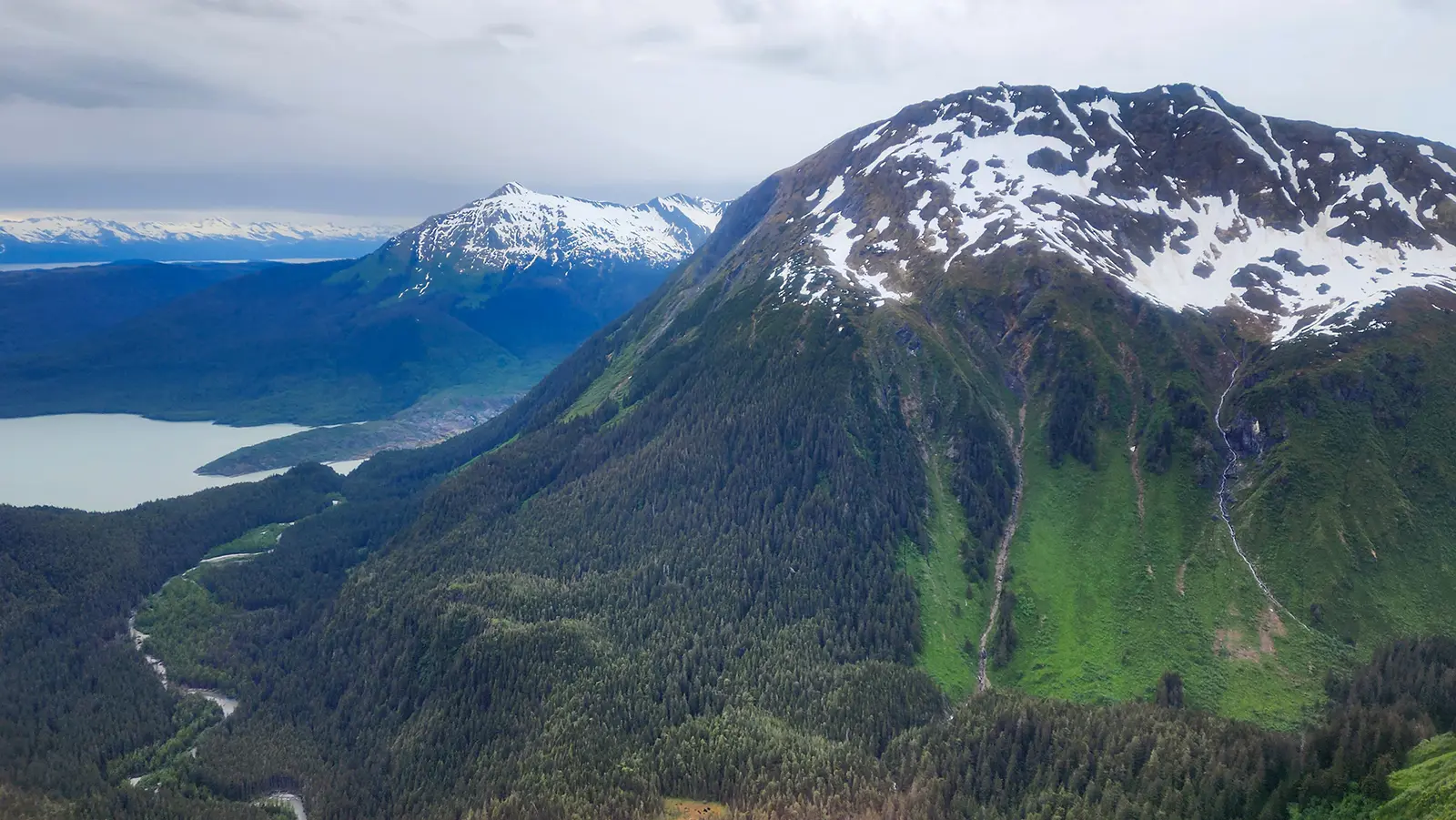 Aerial view from a TEMSCO helicopter over Juneau showing Mendenhall Lake and surrounding mountains