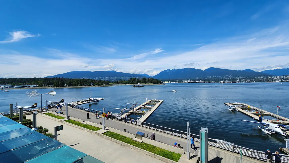 The Vancouver Harbour Flight Centre seaplane dock with mountains and water in Coal Harbour