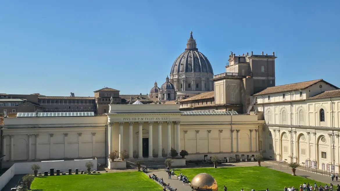 Vatican Museums viewed from the Cortile della Pigna courtyard with the giant bronze pine cone sculpture and visitors