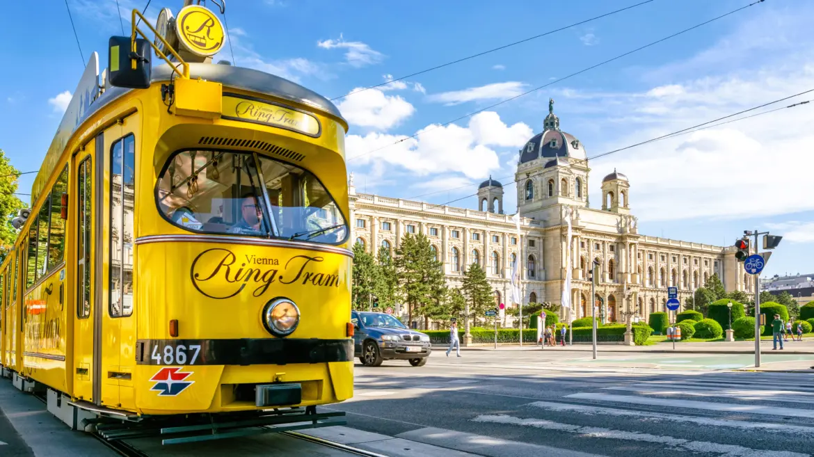 Nostalgic yellow Vienna Ring Tram passing Ringstrasse Ring Road front Kunsthistorisches Museum blend historic transport imperial architecture Vienna Austria