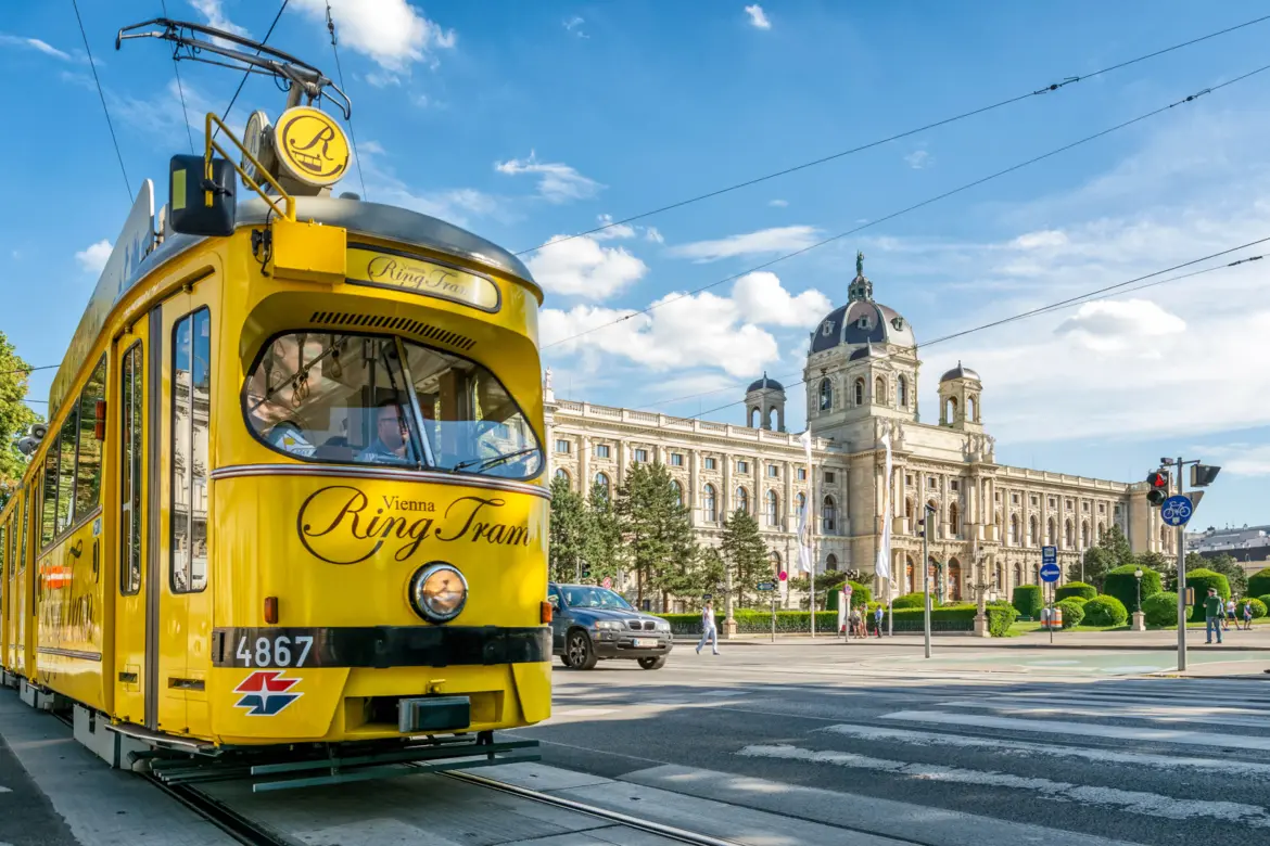 Nostalgic yellow Vienna Ring Tram passing Ringstrasse Ring Road front Kunsthistorisches Museum blend historic transport imperial architecture Vienna Austria