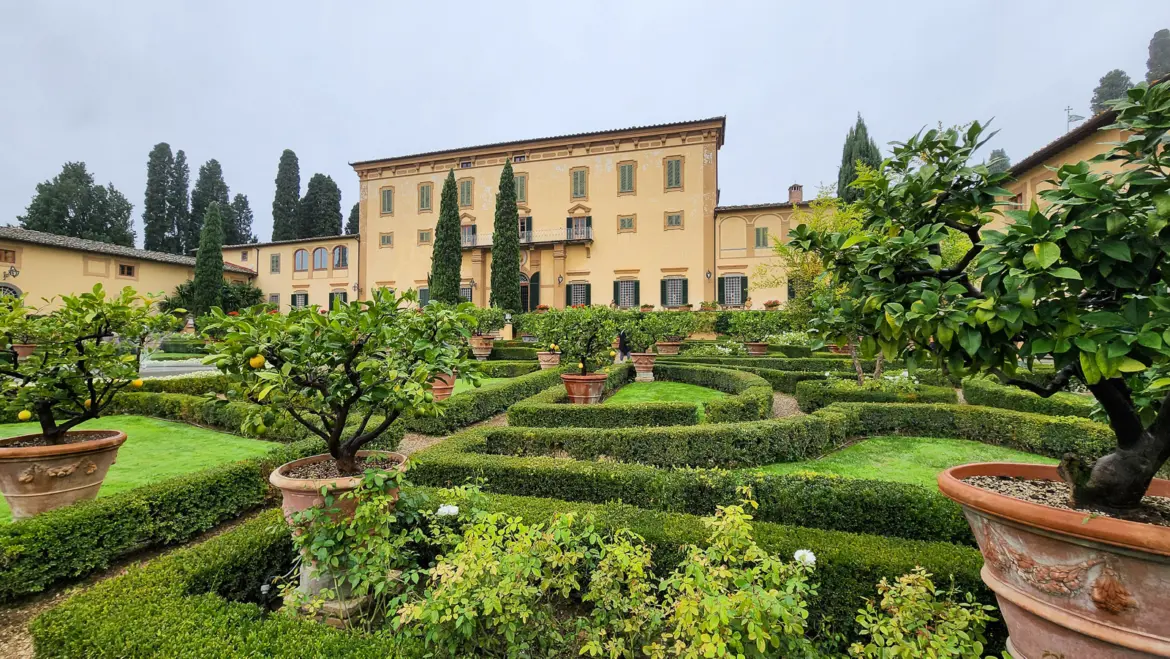 Elegant gardens at the Poggio Torselli estate in Tuscany’s Chianti region, with manicured greenery and panoramic countryside views