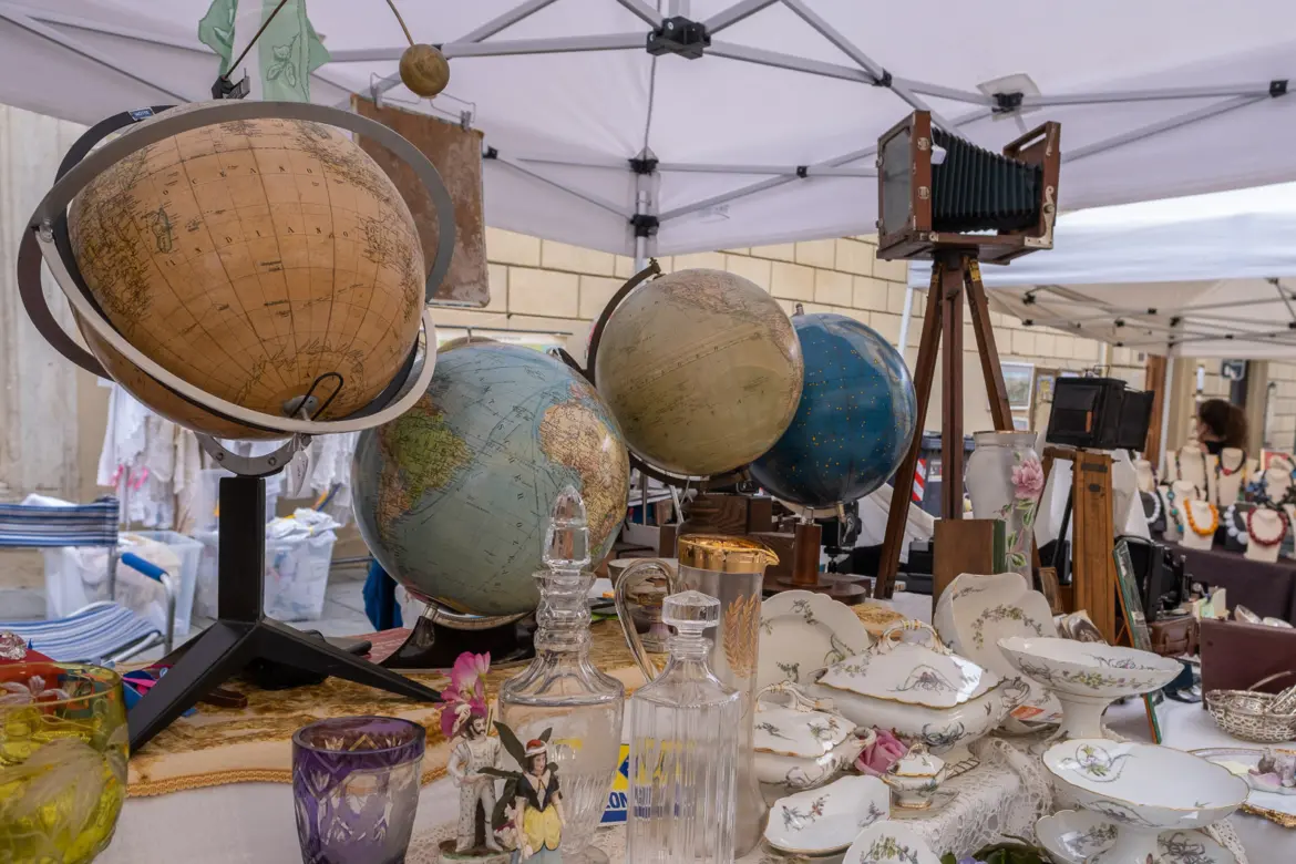 Old globes and porcelain displayed at the famous Arezzo Antique Market, one of Italy’s oldest and largest antiques fairs