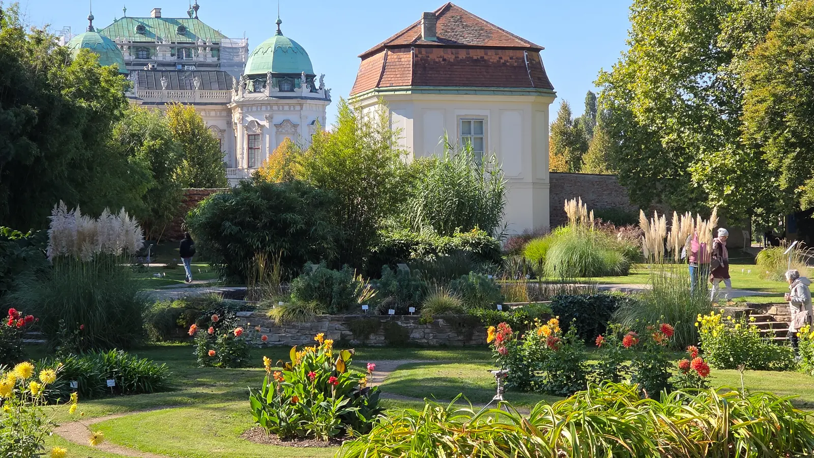 The informal green spaces surrounding the Belvedere in Vienna with landscaped paths and trees offering a peaceful contrast