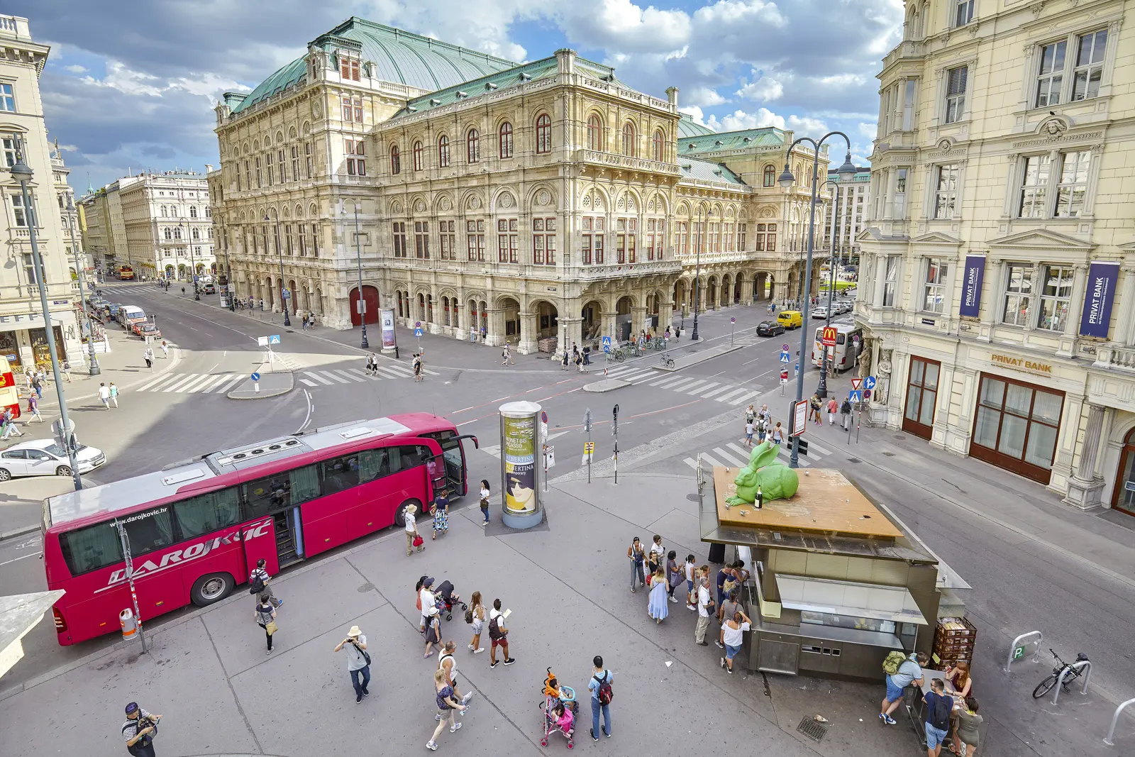View from the Albertina terrace overlooking Bitzinger Würstelstand at Albertinaplatz in Vienna with people queuing