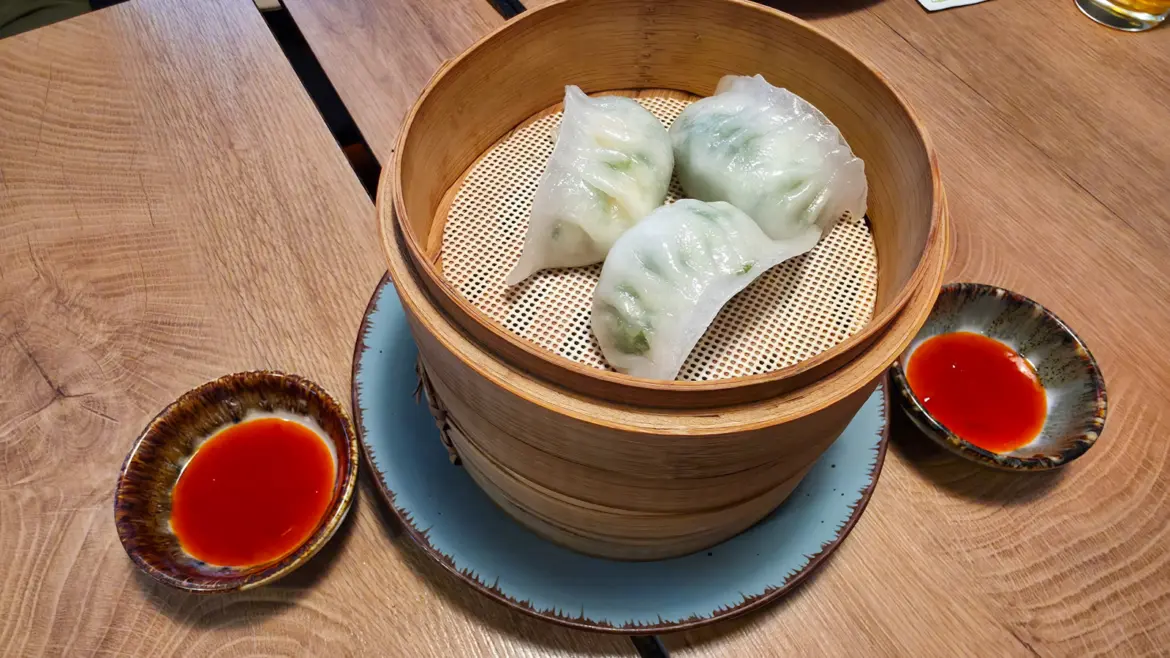 Bärlauch hakao shrimp dumplings with wild garlic served at Chinacy restaurant in Vienna, delicate translucent wrappers filled with aromatic shrimp