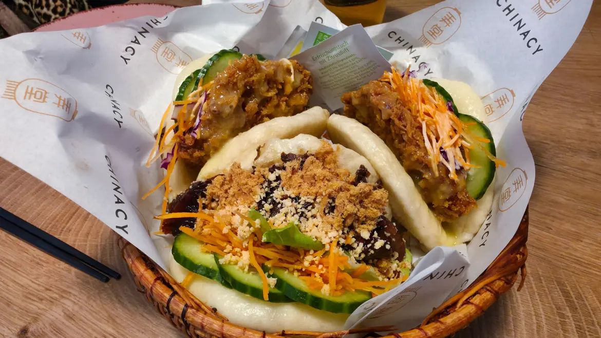Assortment of Crispy Chicken Gua Bao and Classic Gua Bao served at Chinacy restaurant in Vienna, soft fluffy buns with crispy filling