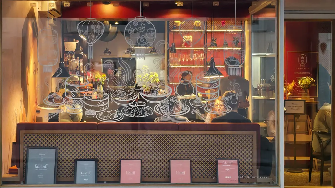 Front window of Chinacy restaurant in Vienna revealing its elegant interior décor, located just steps from the Vienna State Opera