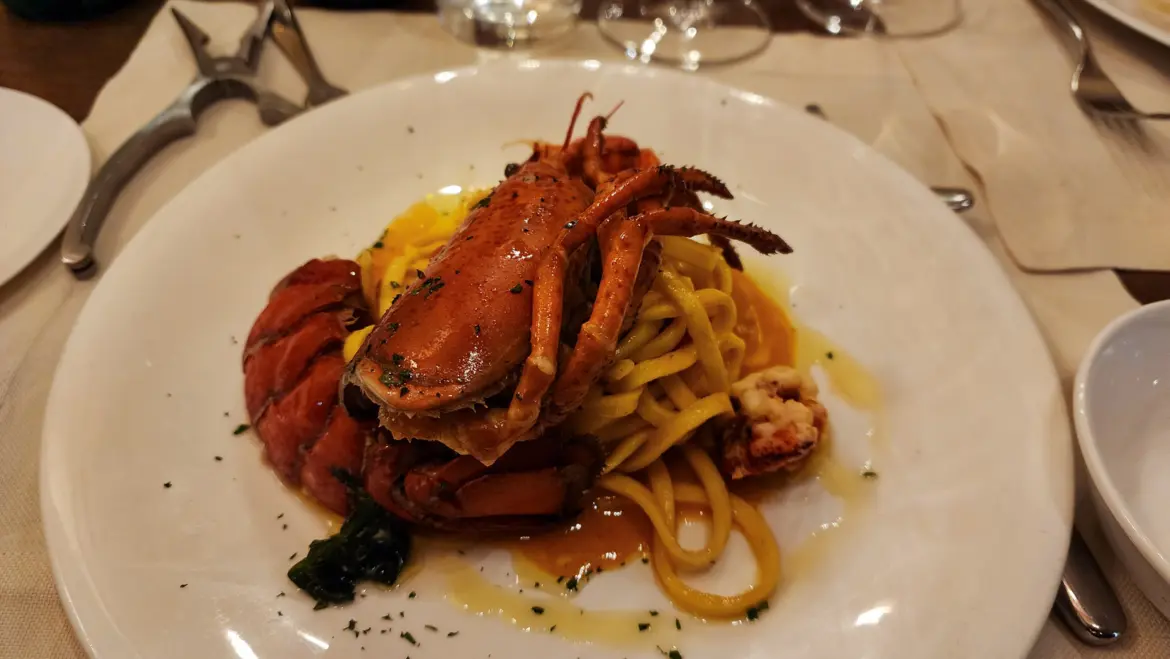 Handmade lobster fettuccini at Osteria del Pavone in Florence, featuring al dente pasta and a rich sauce highlighting delicate lobster in a traditional Tuscan dinner setting
