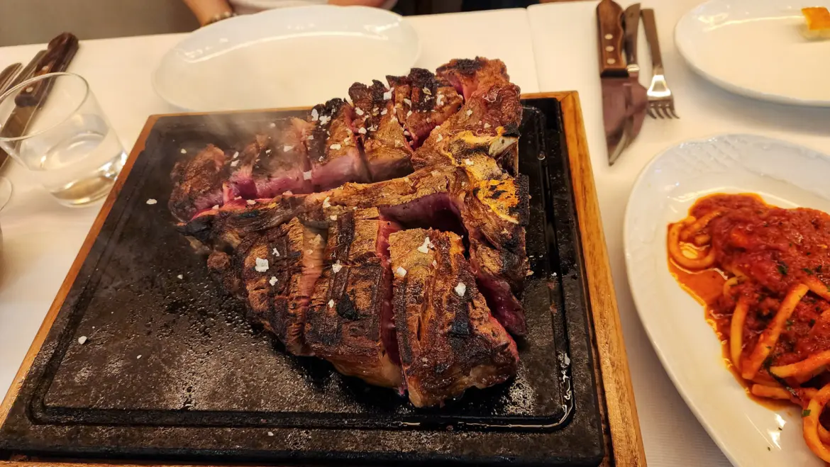 Traditional bistecca alla Fiorentina served at Trattoria Dall’Oste in Florence, the iconic Tuscan T-bone steak with simple seasoning