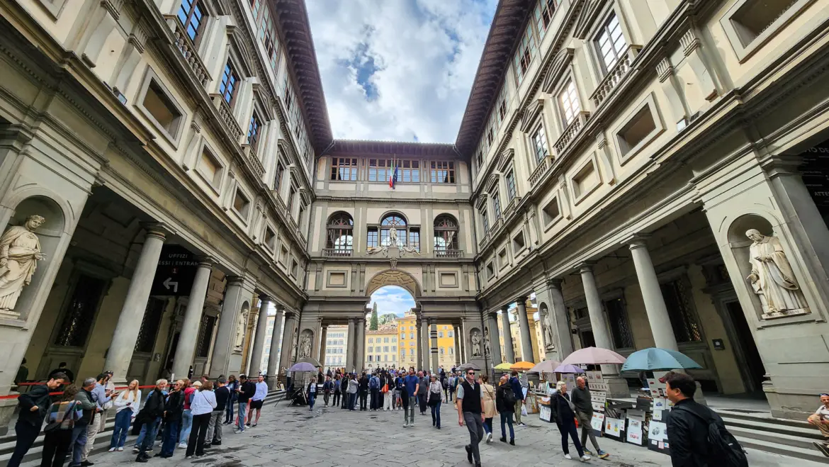The elegant courtyard of the Uffizi Gallery in Florence, designed by Giorgio Vasari for the Medici family, with the corridor framing the sky