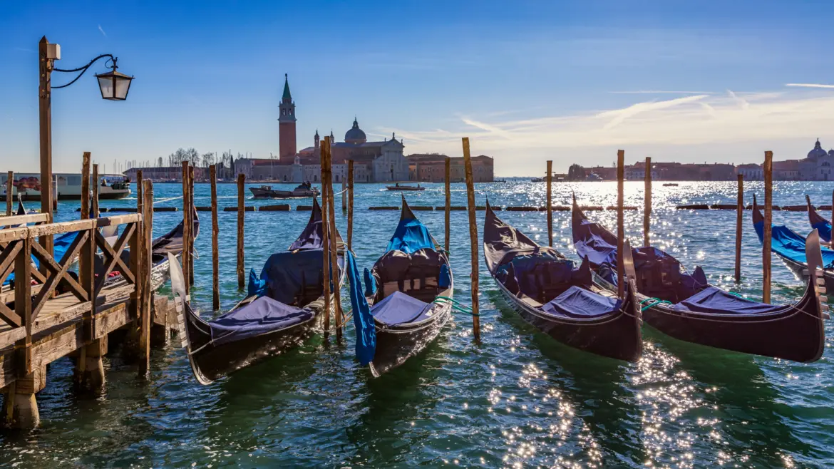 Gondolas moored near St Mark's Square with the Venice skyline in the background