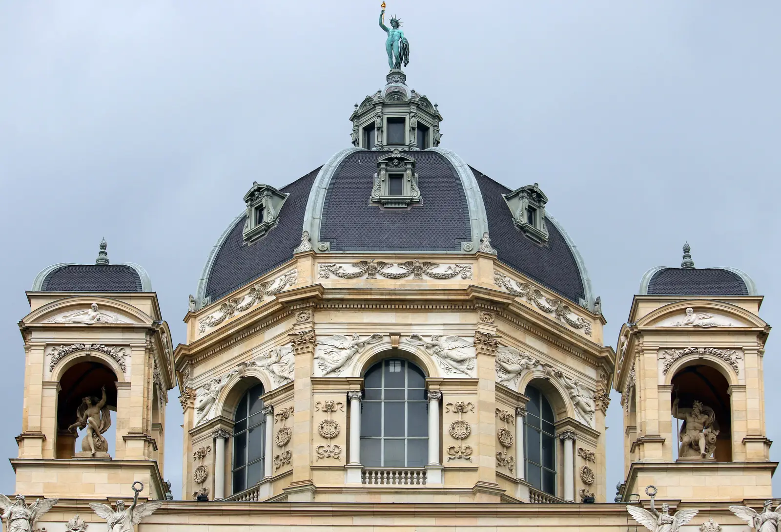 The bronze statue of Helios, the Greek sun god, crowning the dome of the Naturhistorisches Museum Wien in Vienna