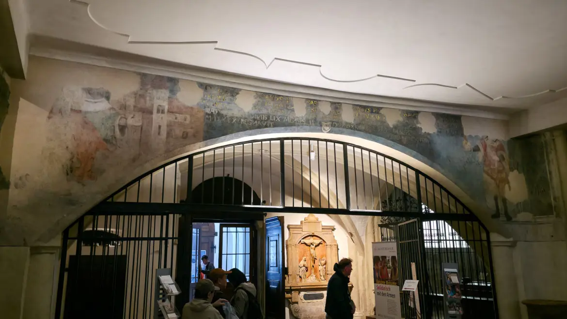 Medieval paintings and faded historic inscriptions near the inner entrance of St. Michael’s Church in Vienna