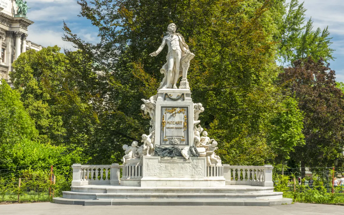 The Mozart monument in Vienna’s Burggarten, a marble statue honouring the composer surrounded by cherubs and musical symbols