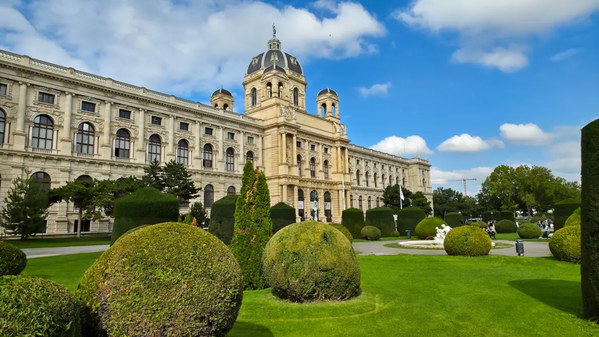 The Natural History Museum Vienna crowned by the bronze statue of Helios, the Greek sun god, rising above Maria-Theresien-Platz