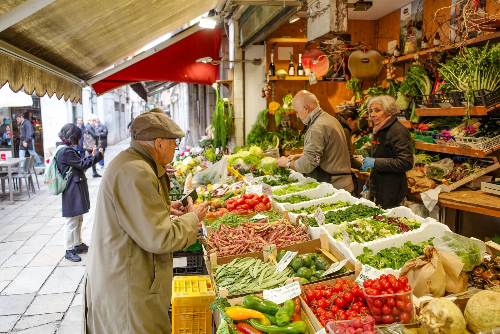 Morning at the Rialto Market in Venice with vendors setting up stalls and fresh produce on display