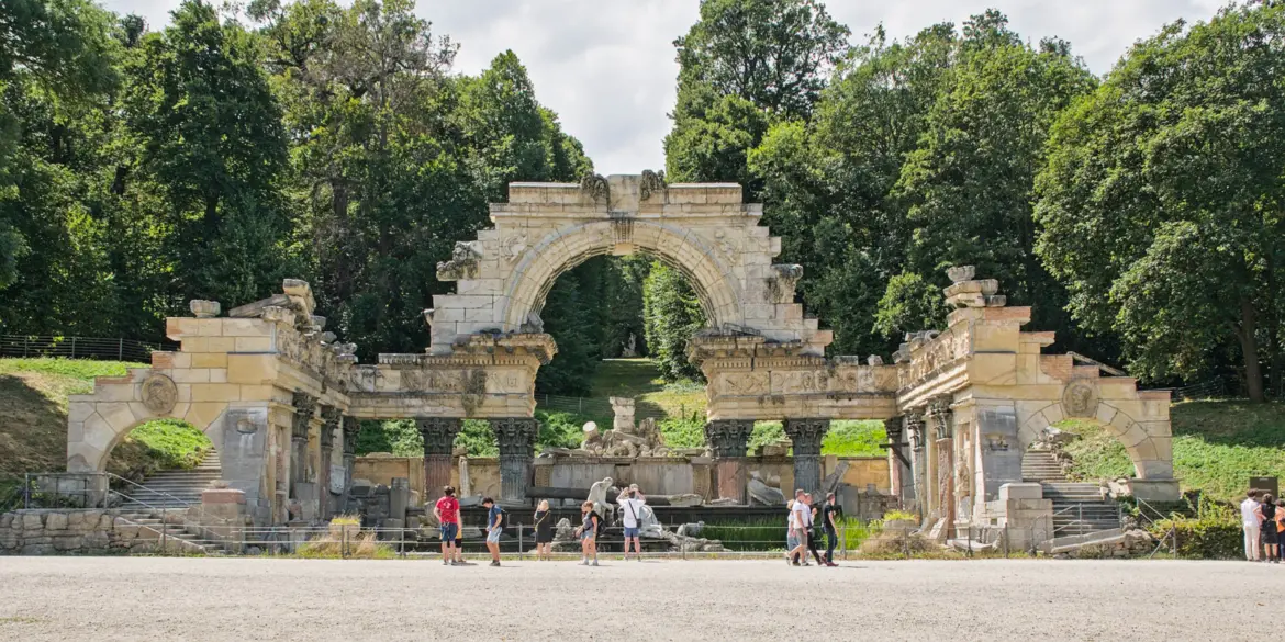 Visitors admiring the atmospheric Roman Ruin in Schönbrunn Gardens, one of the most fascinating hidden corners of the imperial grounds