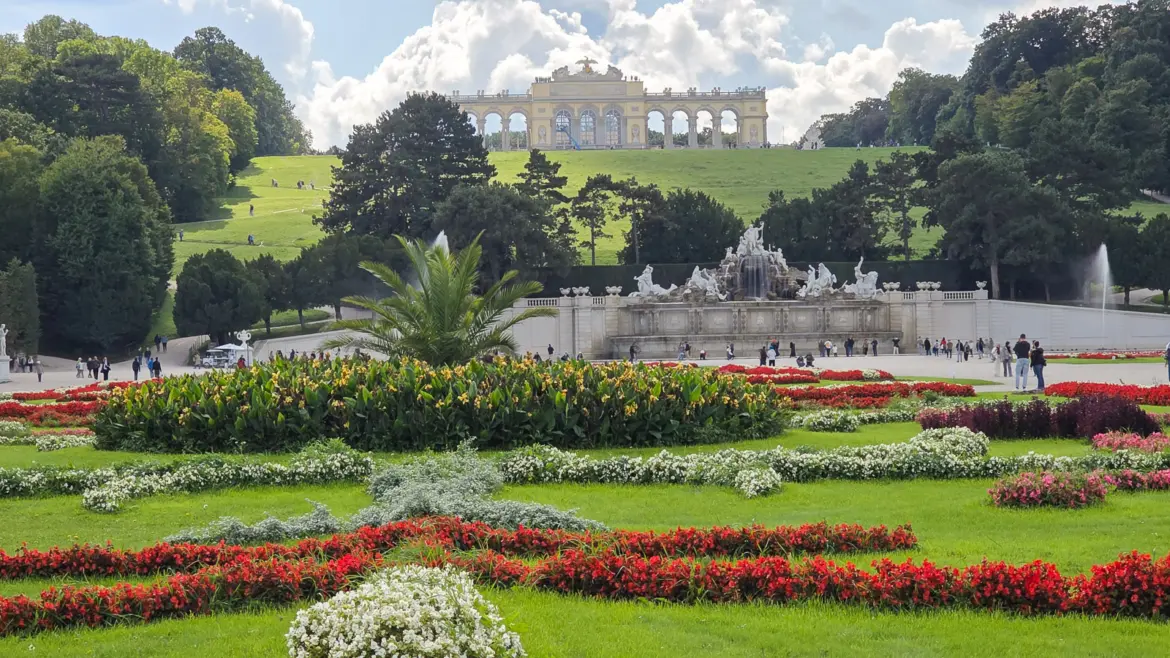 The Gloriette monument standing atop the hill above the Schönbrunn Palace gardens in Vienna, a neoclassical structure overlooking the imperial landscape