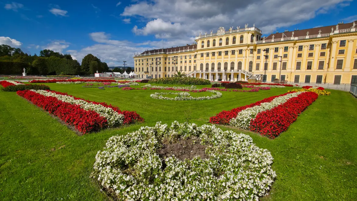The Great Parterre at Schönbrunn Palace in Vienna, with formal garden paths and symmetrical landscaping leading toward the palace façade