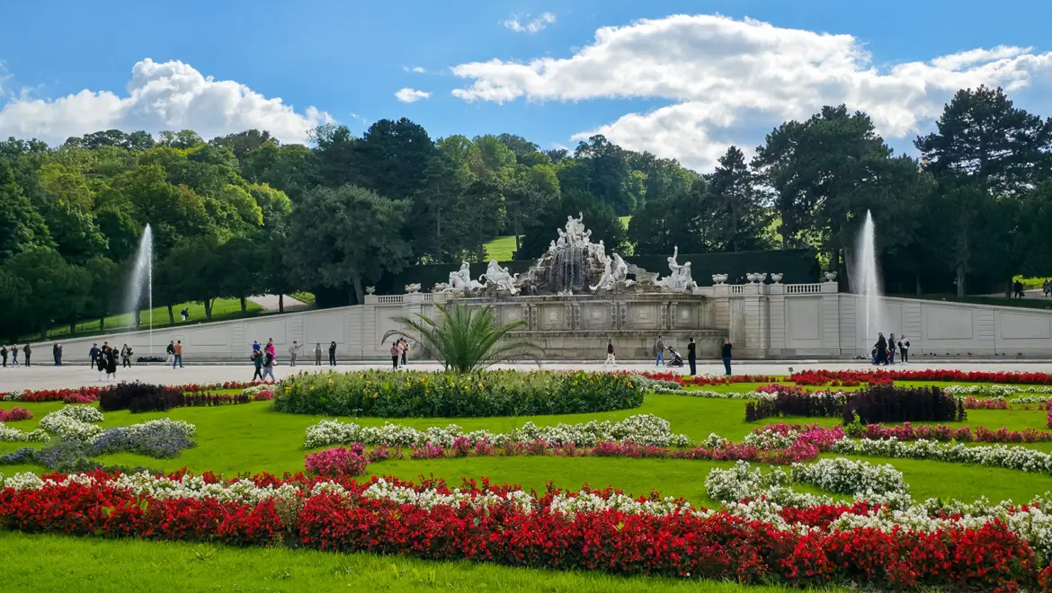 The dramatic Neptune Fountain at the far end of the Great Parterre in the Schönbrunn Palace gardens in Vienna, a Baroque sculptural centerpiece