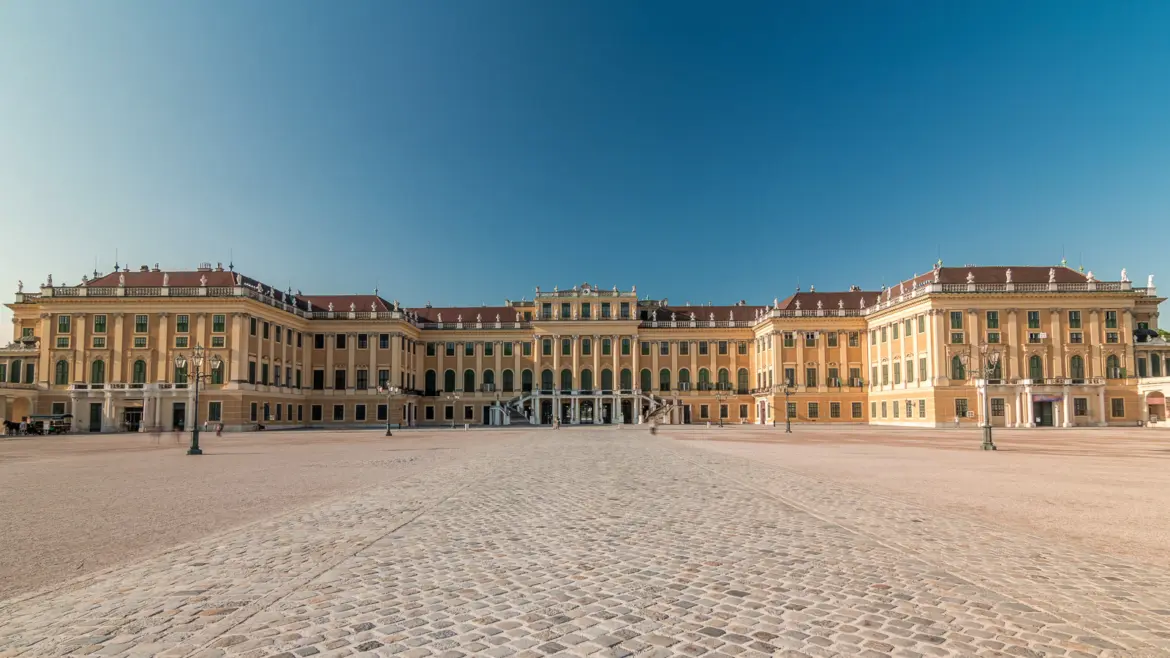 View of Schönbrunn Palace from the main entrance courtyard in Vienna, showcasing the grand yellow Baroque façade of the former Habsburg summer residence