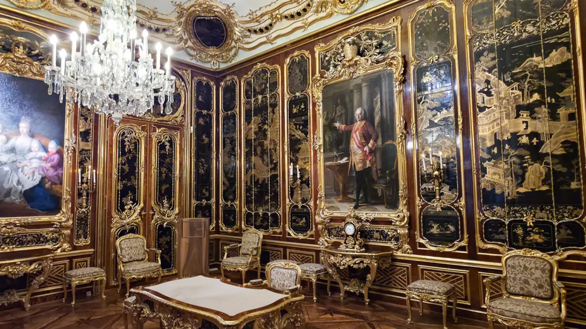 Lavish imperial interior room inside Schönbrunn Palace in Vienna with gilded decoration, antique furniture, and ornate wall coverings reflecting Habsburg court elegance
