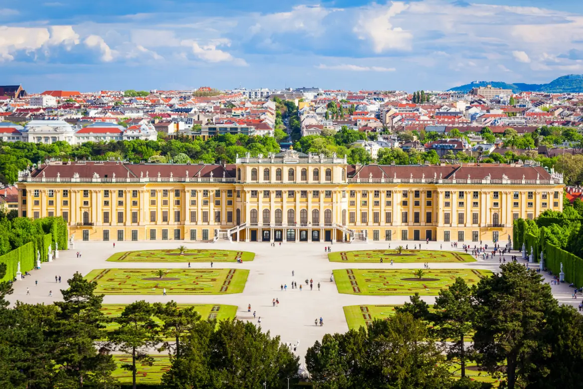 Panoramic view of Schönbrunn Palace and its formal gardens from the Gloriette hilltop in Vienna, offering one of the most spectacular perspectives of the Habsburg estate