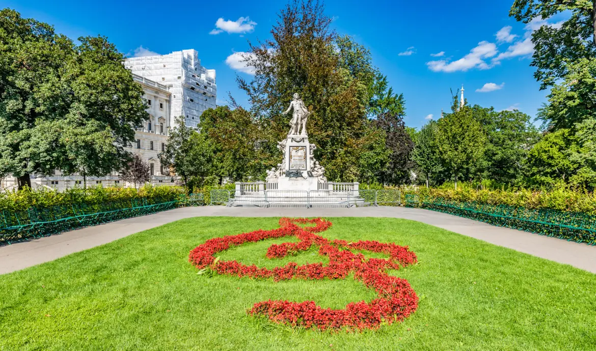 The famous Mozart statue surrounded by colorful flowers in Burggarten, a historic imperial garden next to the Hofburg Palace in Vienna