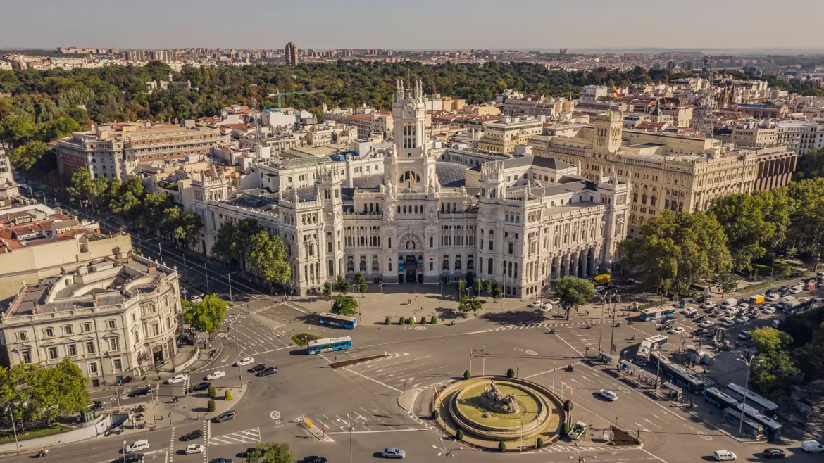 Aerial view of Plaza de Cibeles in Madrid showing the fountain Palacio de Cibeles and converging boulevards