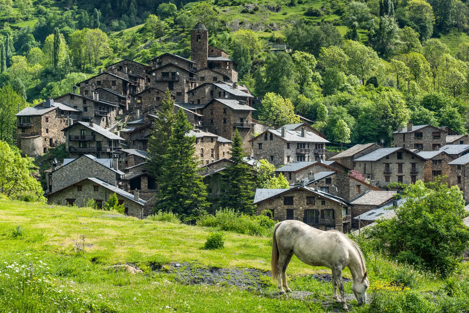 The Principality of Andorra nestled high in the Pyrenees between Spain and France, with stone chalets, winding valley roads, and crisp alpine air stretching toward distant peaks