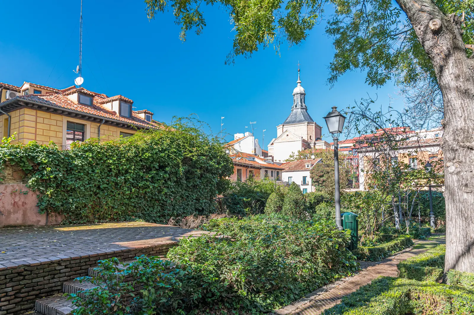 Geometric boxwood hedges and patterned stone paths in the Anglona Garden in La Latina Madrid