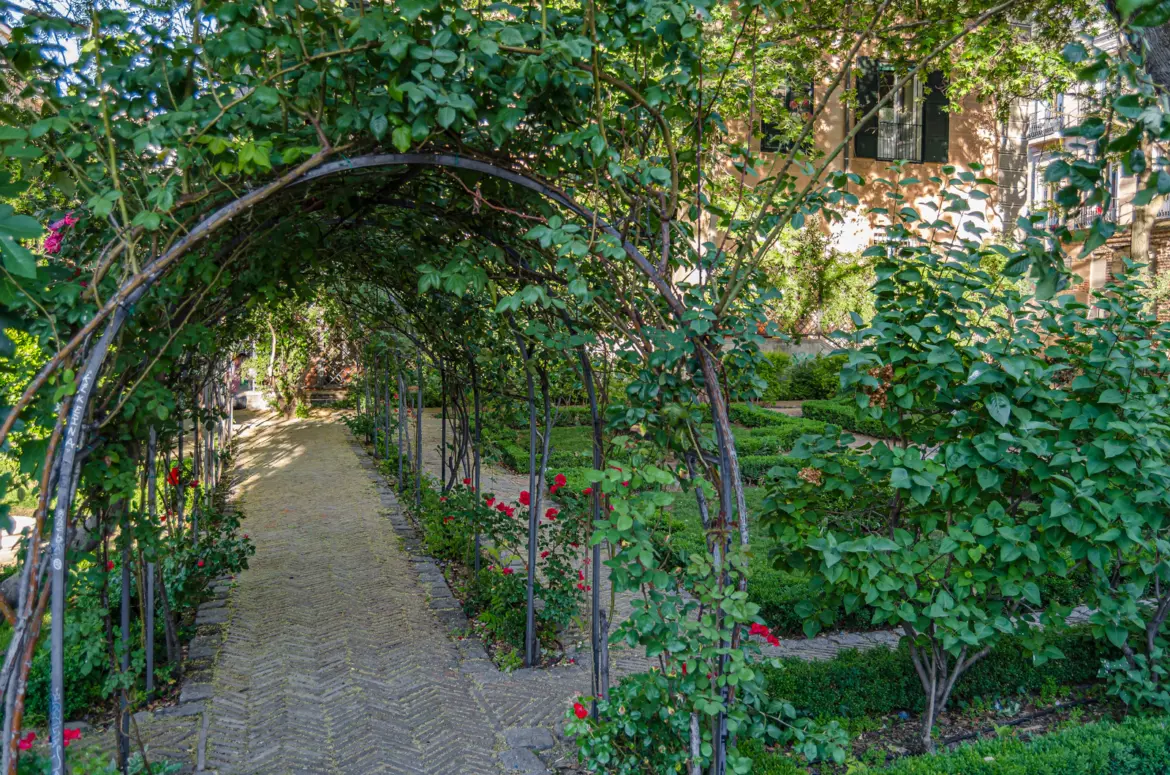 Overview of El Jardín del Príncipe de Anglona in La Latina Madrid with boxwood hedges palace façade and stone walls