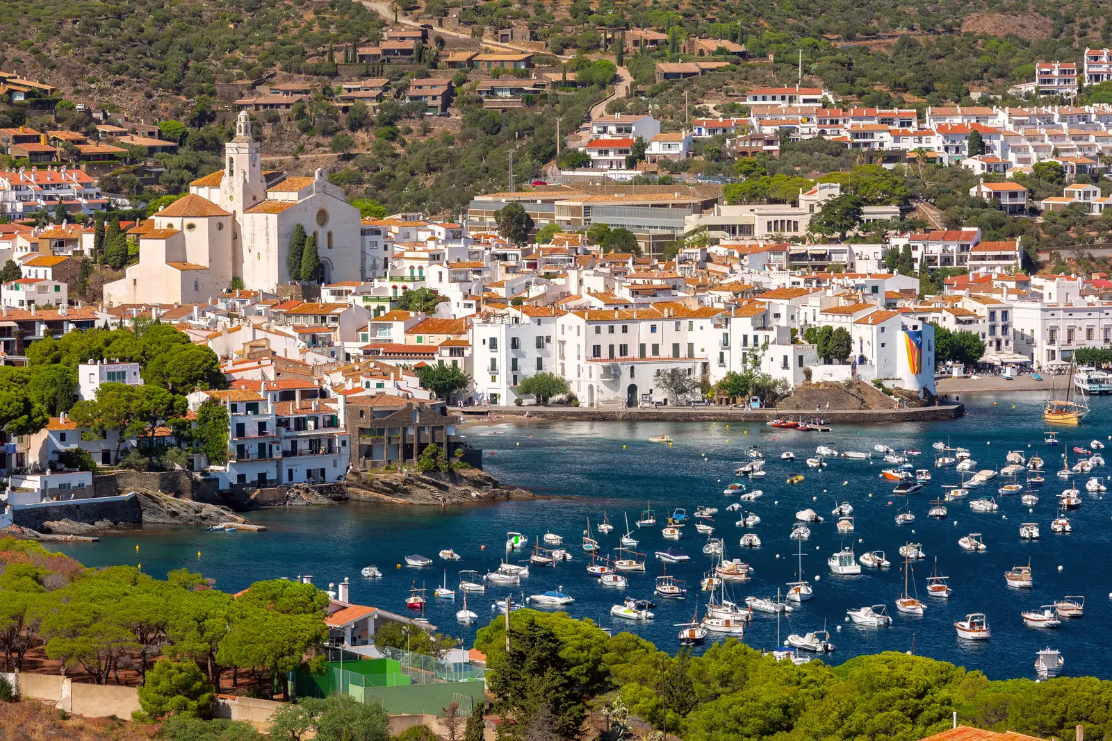 The white buildings of Cadaqués glowing against the deep blue Mediterranean on the Costa Brava, the coastal village where Salvador Dalí found his beloved artistic refuge