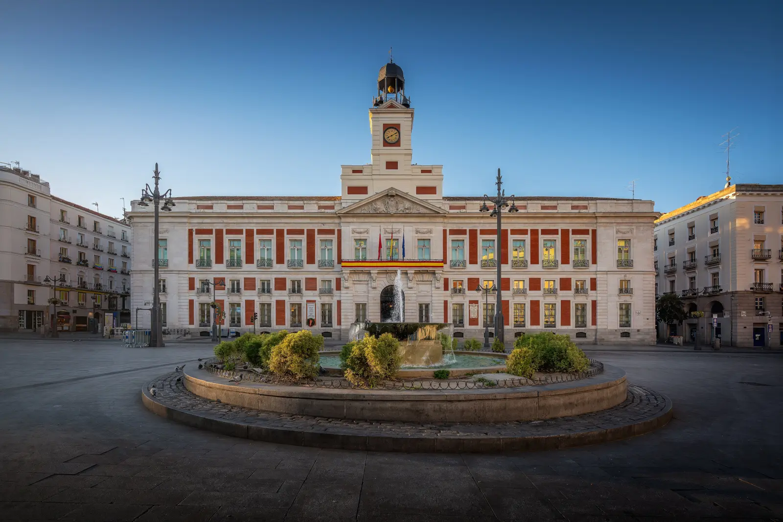 The Casa de Correos with its famous clock tower at Puerta del Sol in Madrid, home to Spain's iconic New Year's Eve twelve grapes tradition