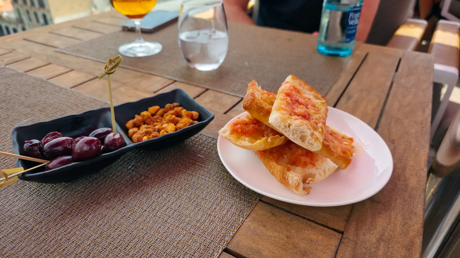 Pa amb tomàquet (bread with tomato) at La Dolce Vitae rooftop, Majestic Hotel Barcelona — thick toasted bread rubbed with tomato, drizzled in olive oil, and sprinkled with salt