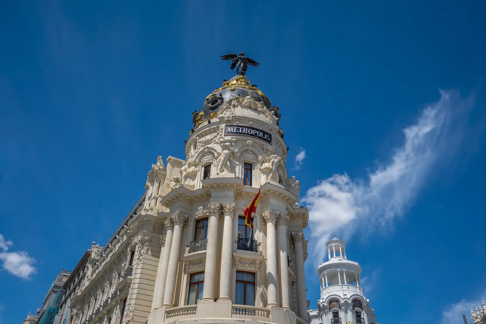 The Edificio Metrópolis with its winged Victory statue and ornate golden dome at the start of Gran Vía in Madrid