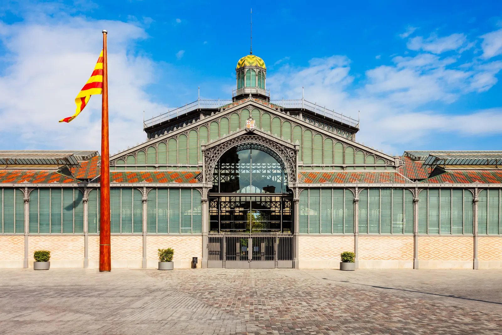 Inside El Born Cultural Center in Barcelona, with the preserved archaeological remains of the medieval Ribera neighborhood visible beneath the elevated walkways and glass floor
