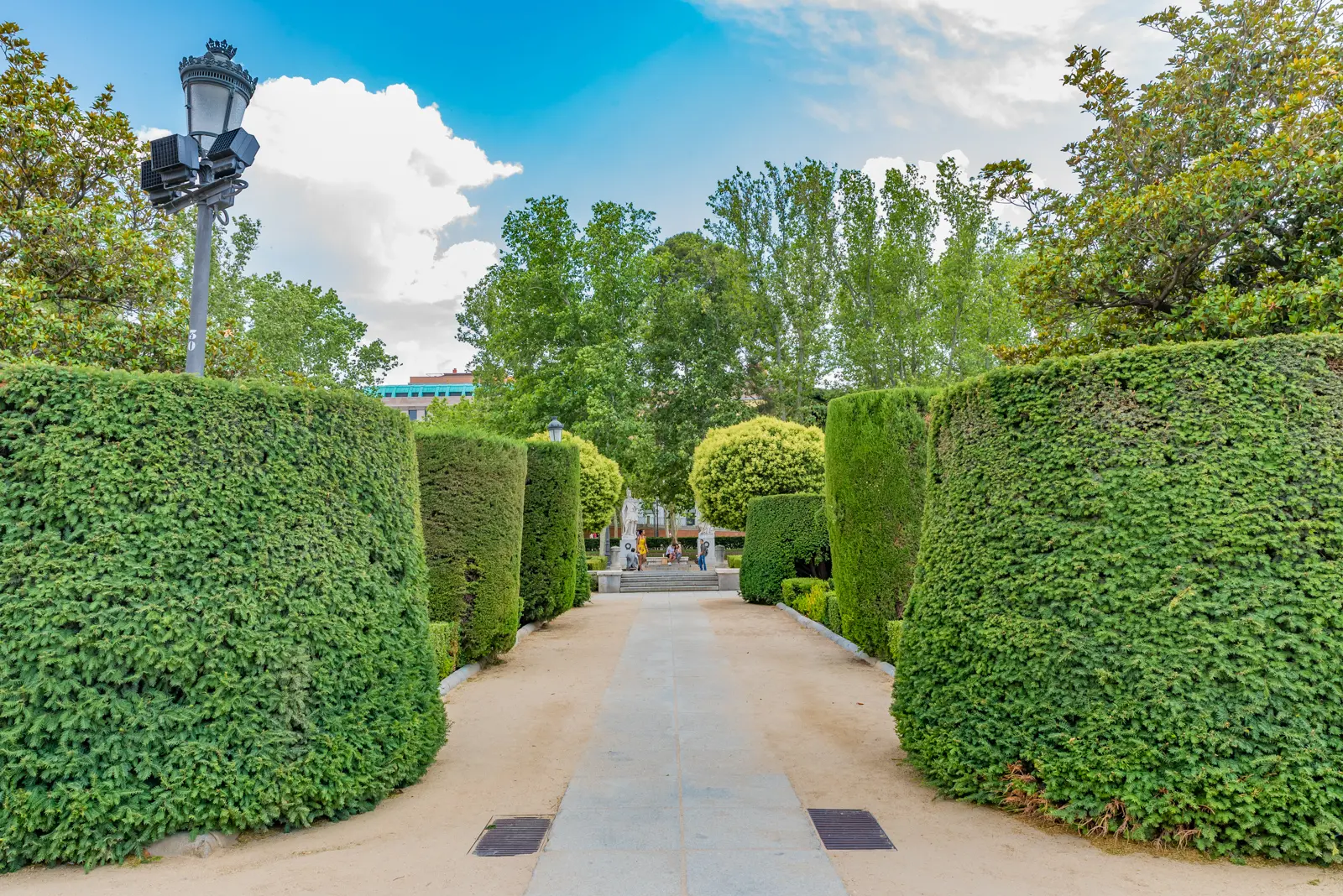Gardens with balustrades sculpted hedges and the Royal Palace at Plaza de Oriente in Madrid