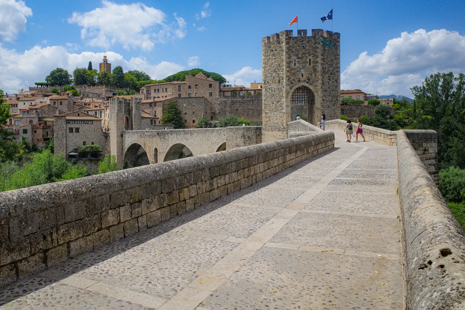 The medieval walls of Girona built on ancient Roman foundations, offering sweeping panoramic views of the colorful houses along the Onyar river and the Catalan city's rooftops