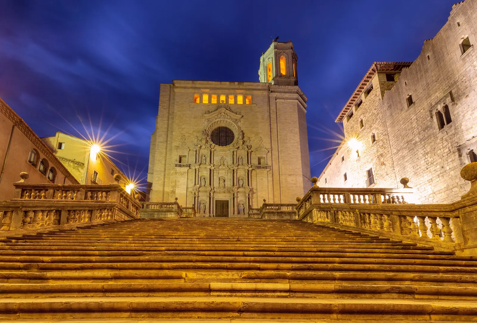 The magnificent Cathedral of Santa Maria in Girona, rising above the old town with its vast Gothic nave — the widest of its kind — and grand Baroque staircase leading to the entrance