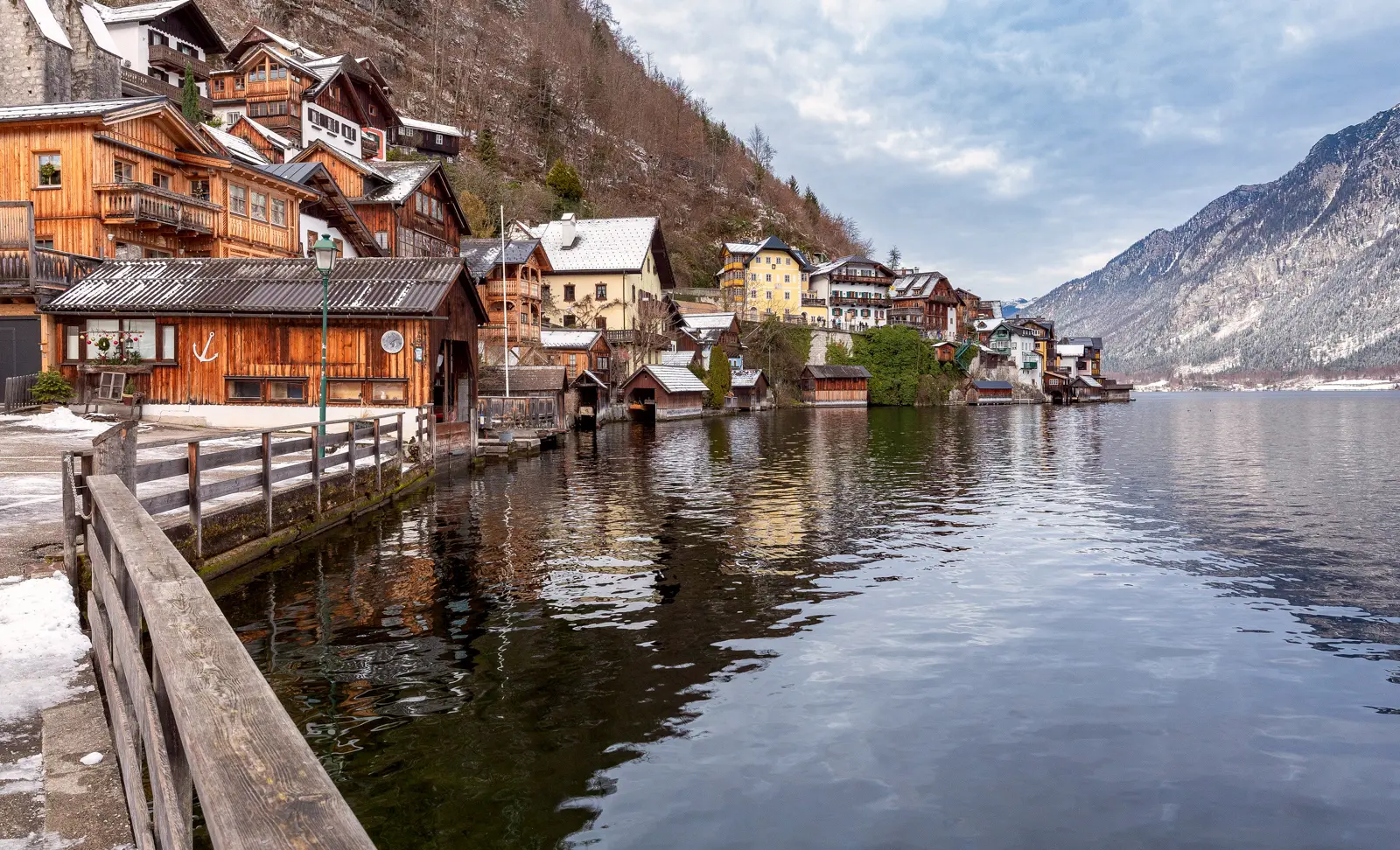 Snow-covered Hallstatt and Lake Hallstatt in winter, reflecting a calm and cinematic atmosphere