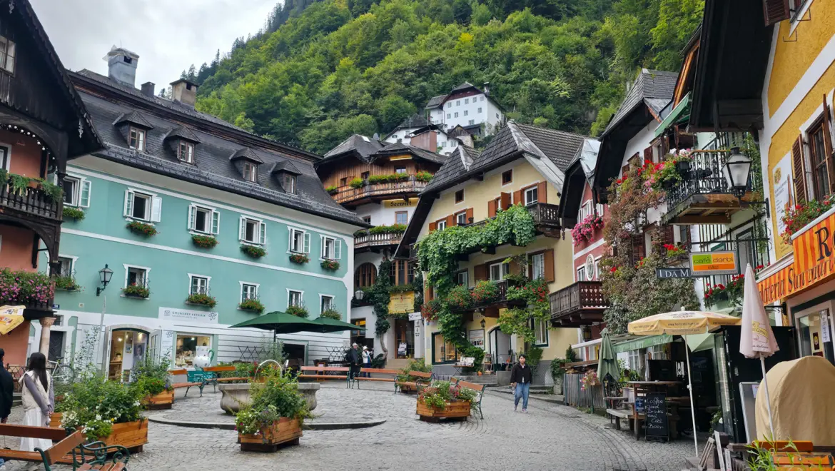 Late afternoon view of Hallstatt with pastel houses, flower boxes, and the calm atmosphere as the day begins to slow and crowds thin in this alpine village