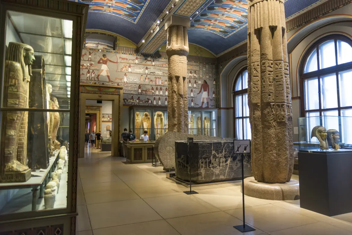 Gallery view of the Egyptian and Near Eastern Collection at Kunsthistorisches Museum in Vienna showing sarcophagi, statues and ancient artifacts