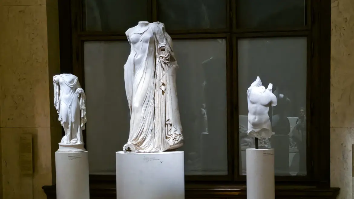 Ancient Greek sculptures highlighting the human form and flowing drapery in the Collection of Greek and Roman Antiquities at the Kunsthistorisches Museum Vienna