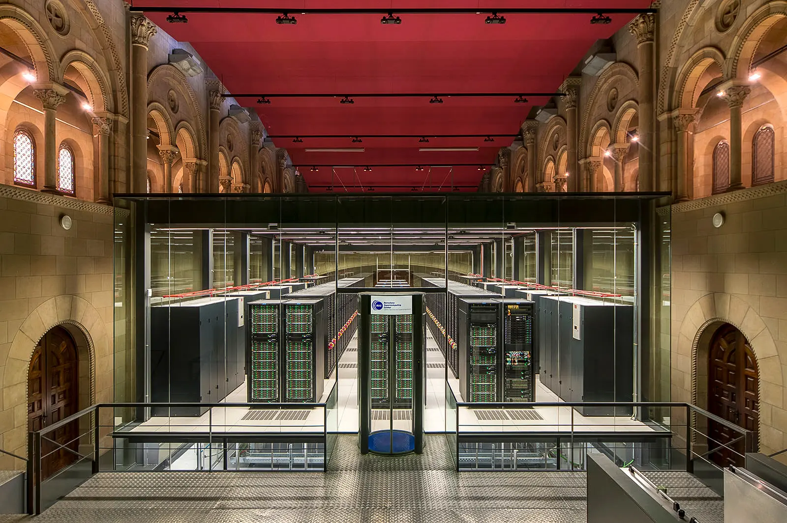 The MareNostrum supercomputer inside the former Torre Girona chapel in Barcelona, with rows of glowing servers set within 19th-century stone arches — a fusion of sacred architecture and cutting-edge technology