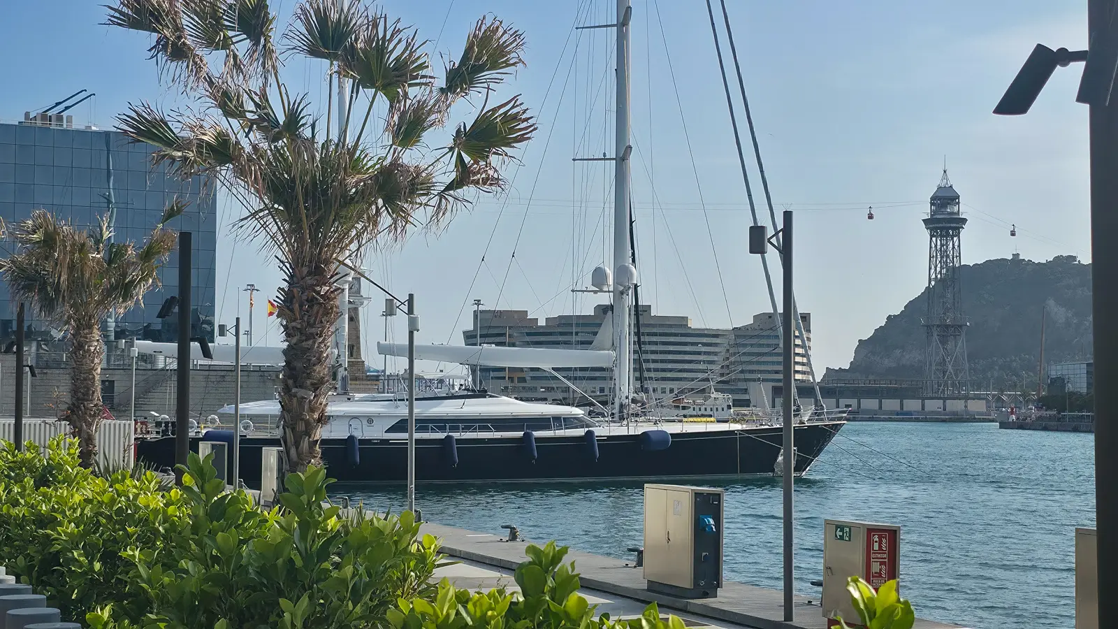 Marina Port Vell pier view in Barcelona during evening light, with yachts and harbour reflections