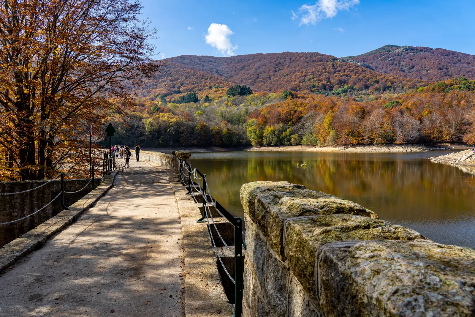 Sweeping panoramic views from the peaks of Montseny Natural Park in Catalonia, with layered valleys, forested ridges, and a vast sky stretching to the Mediterranean horizon