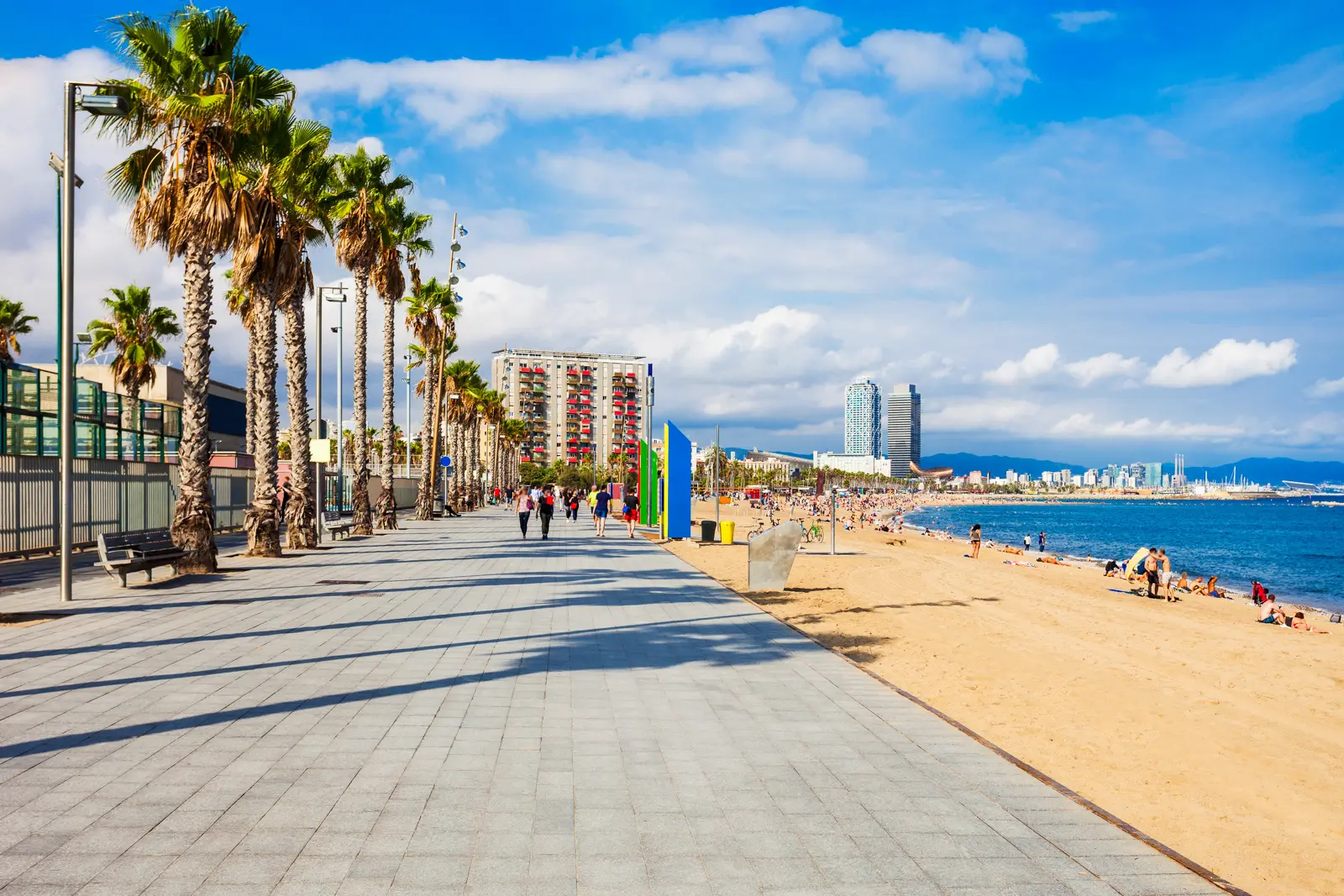 The Passeig Marítim de la Barceloneta boardwalk promenade in Barcelona, with palm trees and Mediterranean views
